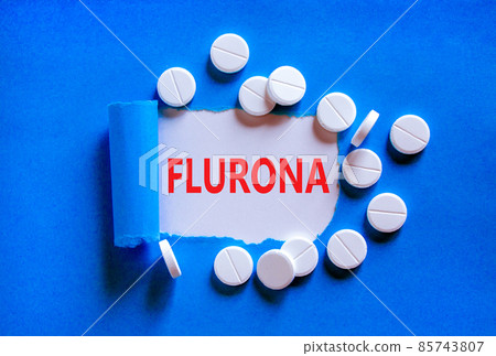 Covid-19 corona and flu flurona symbol. The concept word flurona appearing behind torn blue paper. White pills. Beautiful blue background. Medical, covid-19 corona and flu flurona concept. Copy space. Covid-19 corona and flu flurona symbol. The concept word flurona appearing behind torn blue paper. White pills. Beautiful blue background. Medical, covid-19 corona and flu flurona concept. Copy space. 85743807