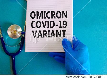 New covid-19 omicron variant strain symbol. Hand in blue glove with white note. Concept words Omicron covid-19 variant. Stethoscope. Medical and COVID-19 omicron variant strain concept. Copy space. 85743810