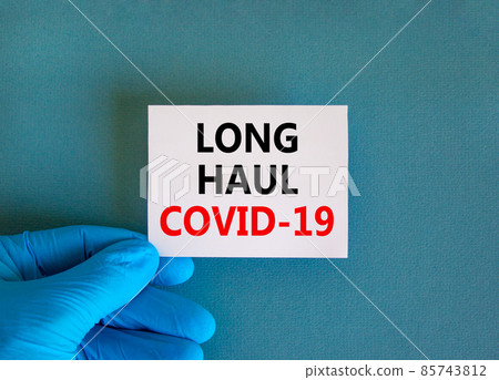 COVID-19 long-haul covid symptoms symbol. White card with words Long haul covid-19. Doctor hand, beautiful blue background copy space. Medical, COVID-19 long-haul covid symptoms concept. COVID-19 long-haul covid symptoms symbol. White card with words Long haul covid-19. Doctor hand, beautiful blue background copy space. Medical, COVID-19 long-haul covid symptoms concept. 85743812