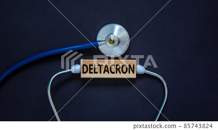 Covid-19 corona deltacron variant symbol. The concept word deltacron on wooden block and stethoscope. Beautiful black background. Medical, covid-19 corona deltacron variant concept. Copy space. 85743824