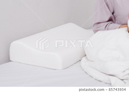Orthopedic Pillow with a Memory Effect. Medical treatment pillow for sleep. Comfort Memory Pillow under the head with a recess under the shoulder isolated on white background. Sleeping Support Pillow. 85743934