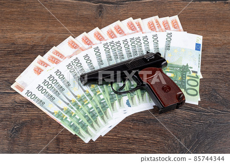 Makarov pistol lies on euro and ruble banknotes. Makarov pistol lies on euro and ruble banknotes. 85744344