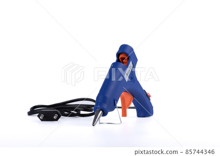 Glue gun with electric cord on a white background. Glue gun with electric cord on a white background. 85744346
