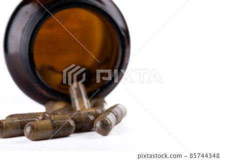 Close-up of a group of dietary supplement or vitamin pills with a defocused bottle in the background. Close-up of a group of dietary supplement or vitamin pills with a defocused bottle in the background. 85744348