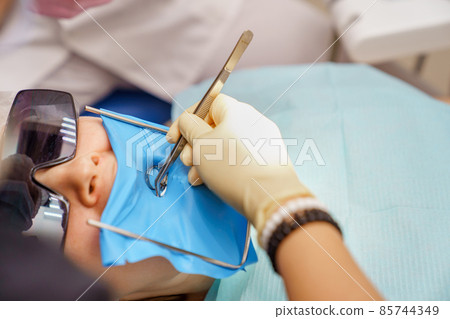 real. dentist treats patient with caries, drills tooth and installs filling real. dentist treats patient with caries, drills tooth and installs filling 85744349