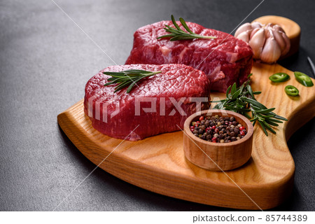 Raw fillet steak cooking on stone table. Raw meat 85744389