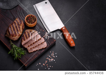 Fresh juicy delicious beef steak on a dark background 85744438