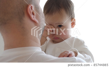 Half-baby hugged by his father and rubbing his eyes Half-baby hugged by his father and rubbing his eyes 85744865