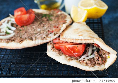 Lahmacun Turkish traditional cuisine, flatbread with minced meat and spices. 85745609