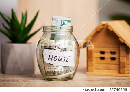 100 dollars in a glass jar with the text house 85746266