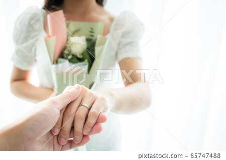 Man surprising his wife in Valentine day or their wedding celemony. Man surprising his wife in Valentine day or their wedding celemony. 85747488