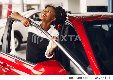 Stylish black woman in a car salon Stylish black woman in a car salon 85748101