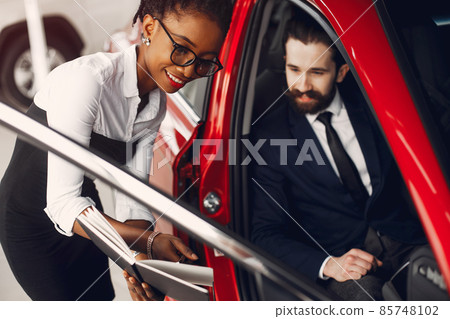 Stylish black woman in a car salon Stylish black woman in a car salon 85748102