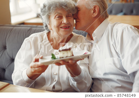 Beautiful old couple sitting in a cafe Beautiful old couple sitting in a cafe 85748149