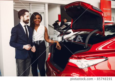 Stylish black woman in a car salon 85748191