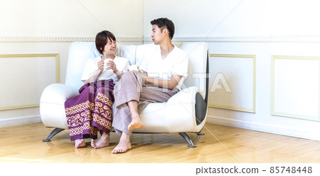 A relaxing couple in the living room 85748448
