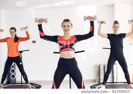 Jumping young women on a trampoline 85749507