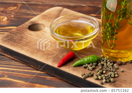 Olive oil and spices on wooden background Olive oil and spices on wooden background 85751162