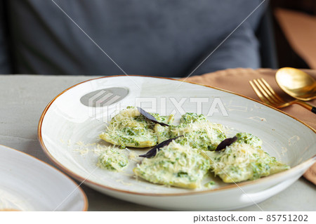 Russian dumpling served with parsley and cheese on plate Russian dumpling served with parsley and cheese on plate 85751202