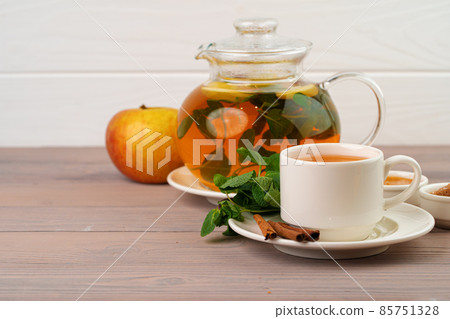 Apple tea drink served on wooden table Apple tea drink served on wooden table 85751328