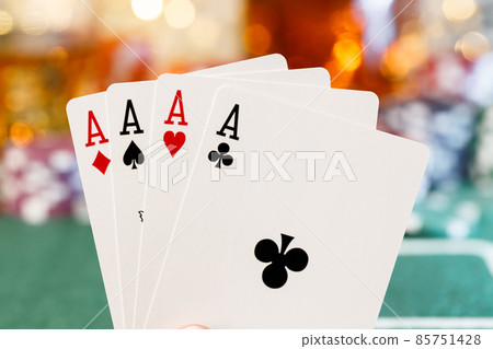 Playing cards on poker table background close up 85751428