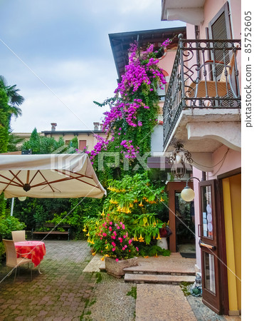 Beautiful red fasade of house at old town at Sirmione town, Italy. 85752605