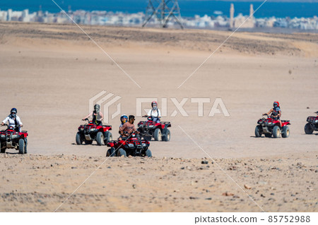 People driving quad bikes during safari trip in Arabian desert not far from Hurghada city, Egypt 85752988
