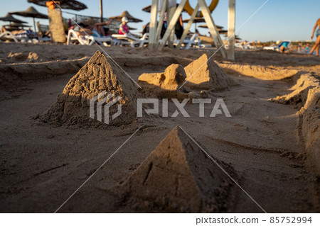 Seascape -view of palm trees, resort beach with sun loungers, umbrellas and the sea. Egypt. 85752994