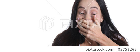 Portrait of woman covering hand over mouth on white background Portrait of woman covering hand over mouth on white background 85753265
