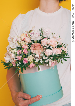 A bouquet of flowers in the hands of a woman A bouquet of flowers in the hands of a woman 85753694