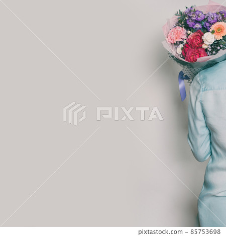 A bouquet of flowers in the hands of a woman A bouquet of flowers in the hands of a woman 85753698