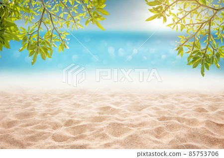 Tropical summer sandy beach focus area at sand floor and bokeh sun light on blurry sea and sky montage photo with plumeria branch as frame Tropical summer sandy beach focus area at sand floor and bokeh sun light on blurry sea and sky montage photo with plumeria branch as frame 85753706