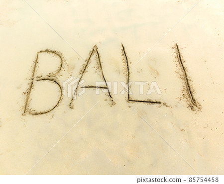 Inscription on the sand Bali. 85754458