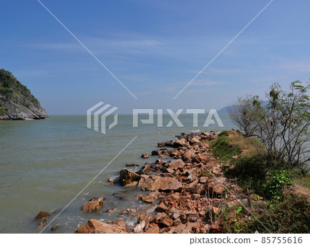 Rocky reef and stone in the green water of sea with mountain and island in background, Beach with blue sky and white cloud at Khao Sam Roi Yot National Park, Thailand Rocky reef and stone in the green water of sea with mountain and island in background, Beach with blue sky and white cloud at Khao Sam Roi Yot National Park, Thailand 85755616