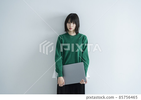 A woman using a laptop computer in the room A woman using a laptop computer in the room 85756465