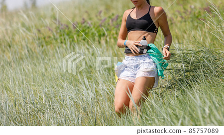 Slim sporty woman descending hill on trail running contest Slim sporty woman descending hill on trail running contest 85757089