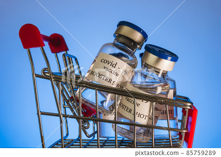COVID-19 booster vaccine vials in shopping cart. Medicine and health care concept COVID-19 booster vaccine vials in shopping cart. Medicine and health care concept 85759289