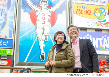 Senior Couple Trip-Winter Trip to Dotonbori, Osaka A lively tourist attraction with flashy famous signs, restaurants and theaters Senior Couple Trip-Winter Trip to Dotonbori, Osaka A lively tourist attraction with flashy famous signs, restaurants and theaters 85760580