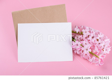 Blank wedding invitation stationery card mockup with envelope on pink background with hyacinth flowers 85761421