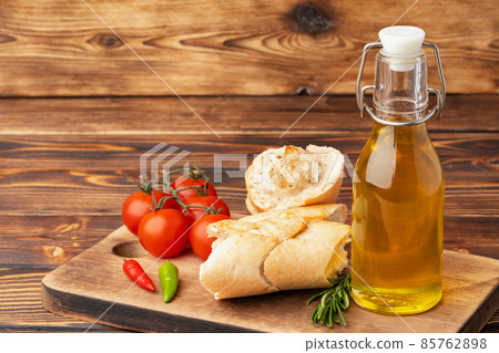 Italian ciabatta bread with olive oil on wooden background 85762898