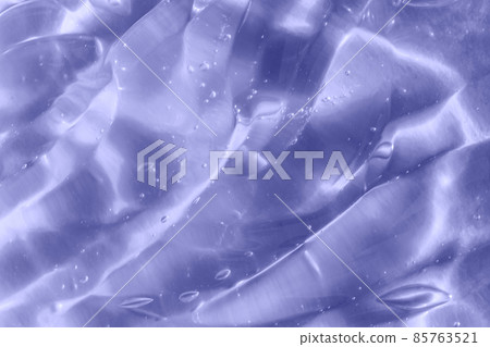 Color of the year 2022. Texture of transparent light violet blue gel with air bubbles and waves on soft background. Concept of skin moisturizing and prevention of covid. Liquid beauty product closeup Color of the year 2022. Texture of transparent light violet blue gel with air bubbles and waves on soft background. Concept of skin moisturizing and prevention of covid. Liquid beauty product closeup 85763521