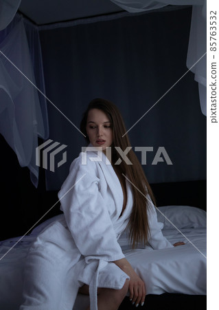 Seductive woman lying on bed at home Seductive woman lying on bed at home 85763532