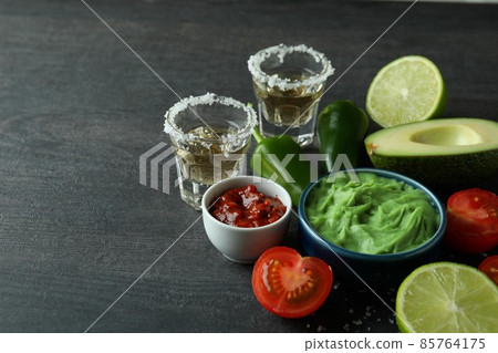 Party concept with tequila, guacamole and chips 85764175