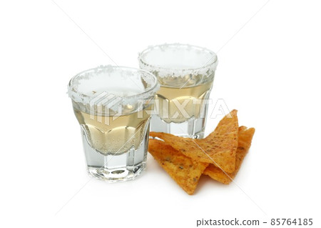 Party concept with tequila and chips isolated on white background Party concept with tequila and chips isolated on white background 85764185