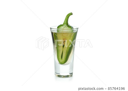 Shot of tequila with pepper isolated on white background Shot of tequila with pepper isolated on white background 85764196