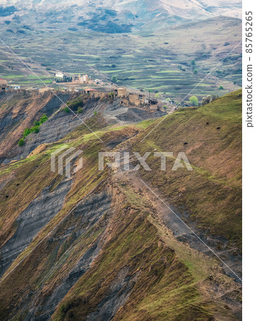 Mountain terrain. High green hills complex mountain landscape, green terraces covered with sparse vegetation slopes. Dagestan, vertical view. 85765265