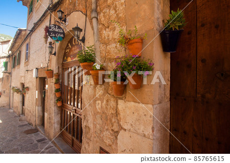 Beautiful street in Valldemossa, famous old mediterranean village of Majorca Spain. Beautiful street in Valldemossa, famous old mediterranean village of Majorca Spain. 85765615