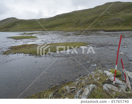 View of marked shallow ford for hikers to crossing mountain river at Duottar lake at Padjelantaleden hiking trail in Swedish Lapland View of marked shallow ford for hikers to crossing mountain river at Duottar lake at Padjelantaleden hiking trail in Swedish Lapland 85765740