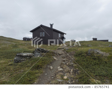 View of mountain huts of STF Duottar fjallstuga cabin at Duottar lake. Lapland landscape Sweden at Padjelantaleden hiking trail. Summer moody sky 85765741