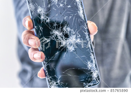 A man who drops from a motorcycle and shows a broken smartphone A man who drops from a motorcycle and shows a broken smartphone 85765890